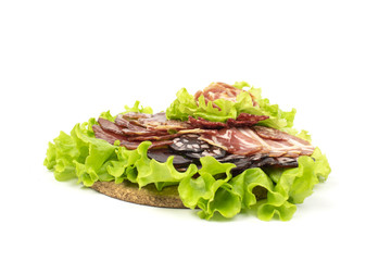 Pieces of meat lying with a leaf of cabbage lying on a cork stand
