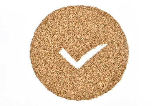 Buckwheat lying on a table in the form of a circle with a bullet point in the middle