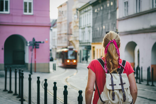Tourist woman looking to arriving tram in ancient city Olomouc, Czech Republic