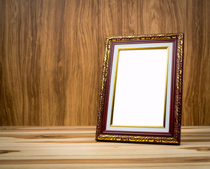 Vintage photo frame on wooden table With a background of wood