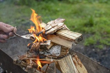 Male hand starts fire for bbq