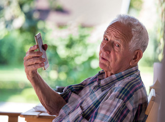 Fototapeta premium Old man talking on mobile phone