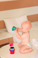 Cute little baby boy playing with stacking cups