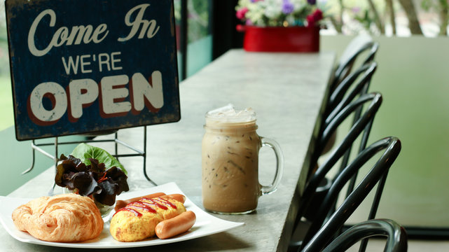 Breakfast table set, Croissant Bread , Omelet , Sausage and ice coffee ready to serve at coffee shop now open.