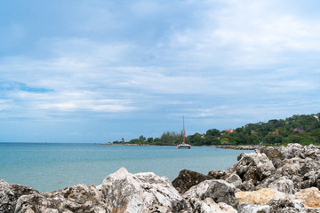 Catamaran Cruise along tropical island coastline 