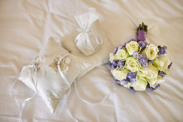 Roses and violet flower bouquet in pastel and cushion for wedding rings