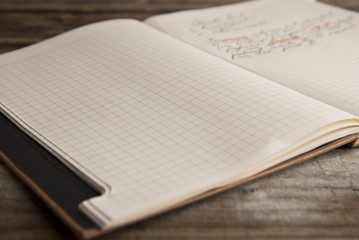 Work and time management, opened notebook over rustic, old textured wooden table. Copy space. Back to school.