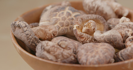 Dried mushroom in wooden bowl