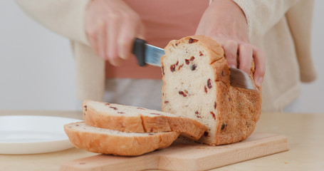 Woman cutting bread
