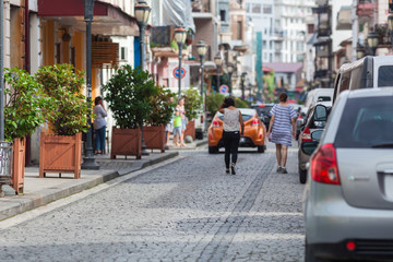 unrecognizable people having walk in city