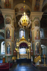 Fototapeta na wymiar Interior with Burning candles in a Russian ortodox church. Close-up of ordinary church