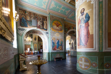 Fototapeta na wymiar Interior with Burning candles in a Russian ortodox church. Close-up of ordinary church