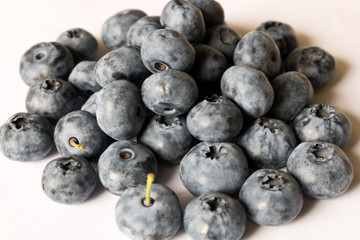 Fresh blueberries on a light background. Close up. The concept of natural food