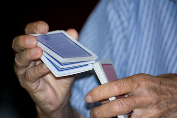 Hands Mixing Up a Bunch of Ramino Cards During a Match