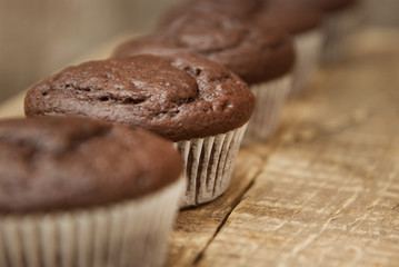 Chocolate muffins. Homemade chocolate muffins with spices on wooden background. Sweet dessert.