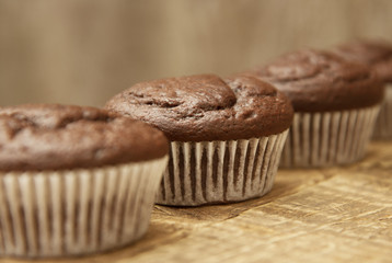Chocolate muffins. Homemade chocolate muffins with spices on wooden background. Sweet dessert.