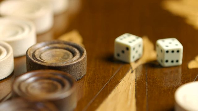 Close up dices and chips on the backgammon surface