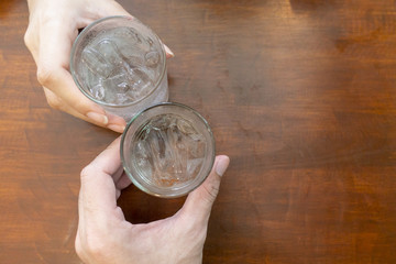 Close up of hand is holding glasses of cold water