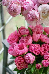 Lovely flowers in glass vase. Beautiful bouquet of pink peonies . Floral composition, scene, daylight. Wallpaper