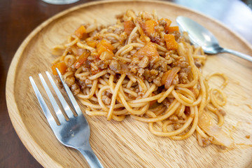close up of spaghetti on wooden dish