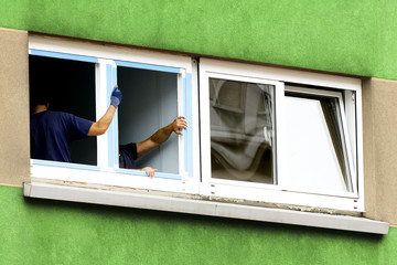 construction workers replacing and installing window