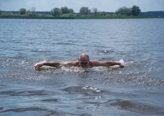 Elderly man swims