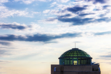Fototapeta premium Glass dome of a building against a background of the evening cloudy sky.