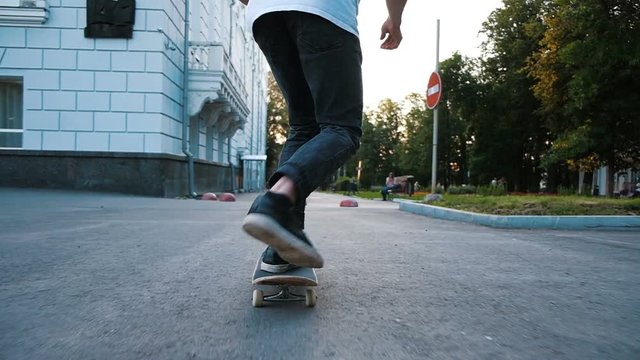 Man does on a skateboard a trick kickflip and fails close up, slow motion