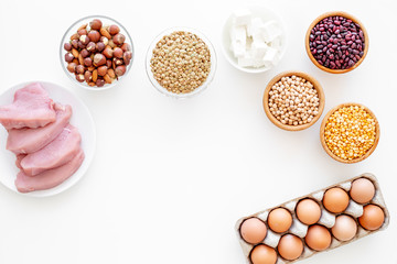 Healthy food. Products rich protein and fiber. Legumes, nuts, low-fat cheese, meet, eggs. Raw beans, chickpeas, lentil, almond, hazelnut on white background top view copy space