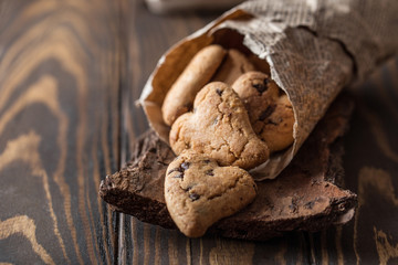 Chocolate cookies on wooden  rustic table. Chocolate chip cookies in the shape of a heart. Homemade cookies