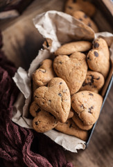 Chocolate cookies on wooden  rustic table. Chocolate chip cookies in the shape of a heart. Homemade cookies