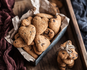 Chocolate cookies on wooden  rustic table. Chocolate chip cookies in the shape of a heart. Homemade cookies