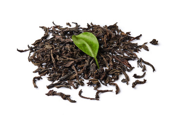 Heap of dried black tea leaves isolated on white background.