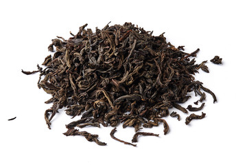 Heap of dried black tea leaves isolated on white background.