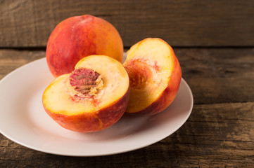 Fototapeta na wymiar Rustic style. Organic fresh ripe peaches on the wooden table.