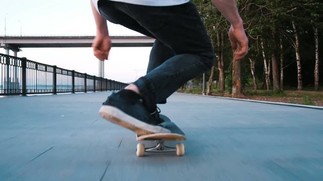 Man is riding a skateboard and is trying to do a trick on a blackboard
