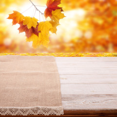 Naklejka na ściany i meble Tableclothe on wooden desk. Autumn background. Top view mock up. Selective focus.