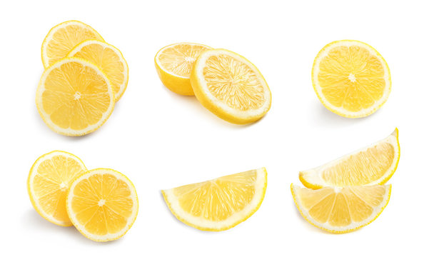 Set with fresh sliced lemons on white background