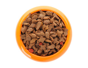 Bowl of dry pet food on white background, top view