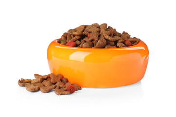 Bowl of dry pet food on white background