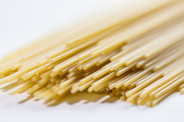 Pasta spaghetti. Heap of pasta on white background. Pasta isolated on white background. Italian pasta close up background. Background of uncooked pasta.