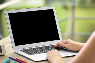 Fototapeta premium Woman working with laptop at home. Mock up with space for text