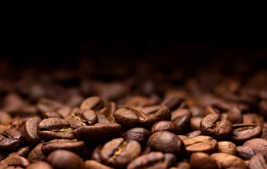 Tuinposter Roasted coffee beans on dark background © xamtiw