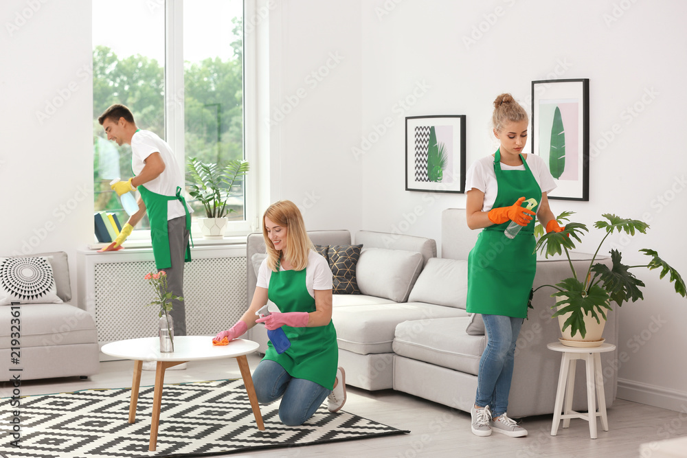 Canvas Prints Team of professional janitors in uniform cleaning living room