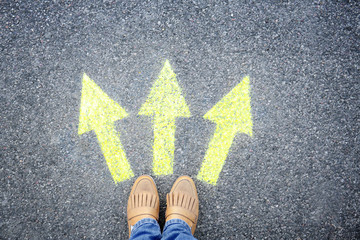 Woman standing on road near arrows marking, closeup