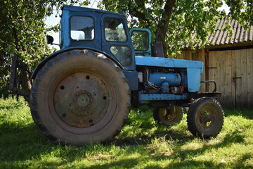 blue old tractor with dirty wheels