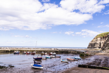 Staithes, North Yorkshire, UK.  A view of Staithes harbour and the Penny Nab headland.