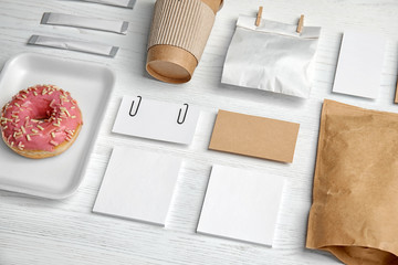 Composition with items for mock up design on wooden background. Food delivery service