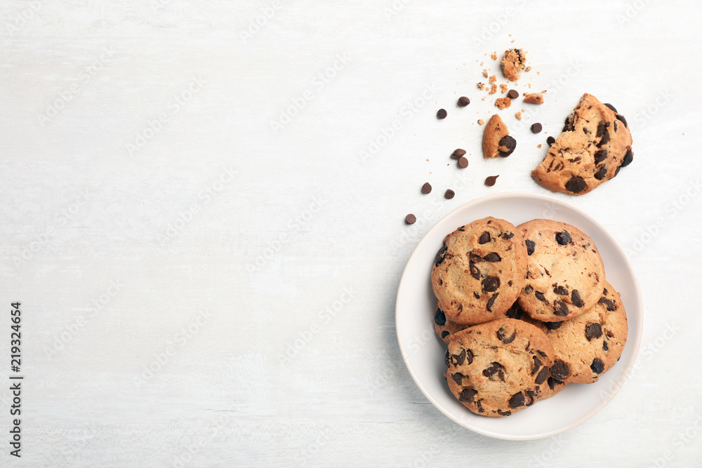 Wall mural flat lay composition with chocolate cookies and space for text on light background