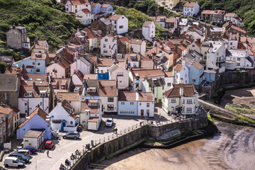 Fototapeta premium A view of the North Yorkshire UK village of Staithes, seen here from from Penny Nab headland.